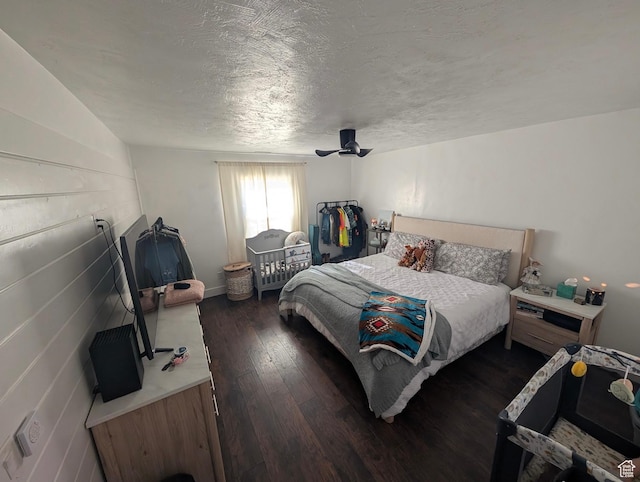 bedroom featuring a textured ceiling, wood finished floors, and ceiling fan