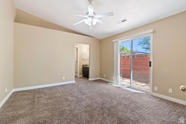empty room featuring visible vents, baseboards, ceiling fan, carpet, and lofted ceiling