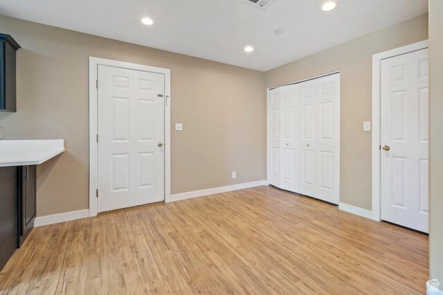 interior space with recessed lighting, visible vents, light wood-type flooring, and baseboards
