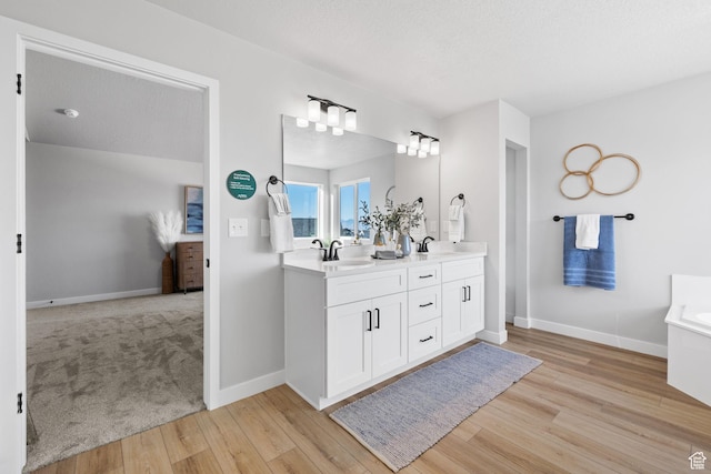 199 N Mia Cv E Unit 12, Saratoga Springs, UT 84045 - full bath with double vanity, wood finished floors, baseboards, and a tub