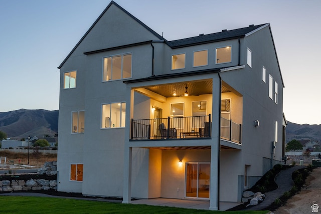 199 N Mia Cv E Unit 12, Saratoga Springs, UT 84045 - back of property with a balcony, stucco siding, a mountain view, and a patio