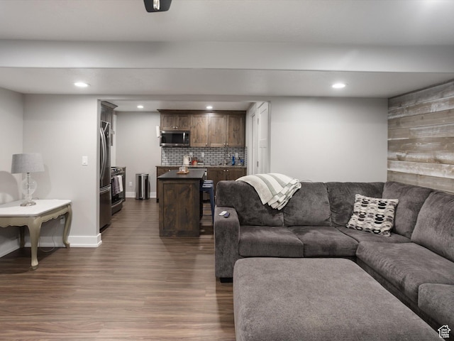 131 Crockett Ave, Logan, UT 84321 - living room featuring dark wood-style floors, recessed lighting, baseboards, and bar with sink