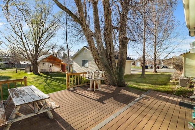 wooden terrace with a residential view and a lawn
