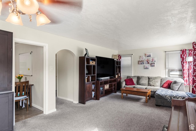 268 S Main St, Malad City, ID 83252 - living area with arched walkways, light colored carpet, baseboards, and a textured ceiling