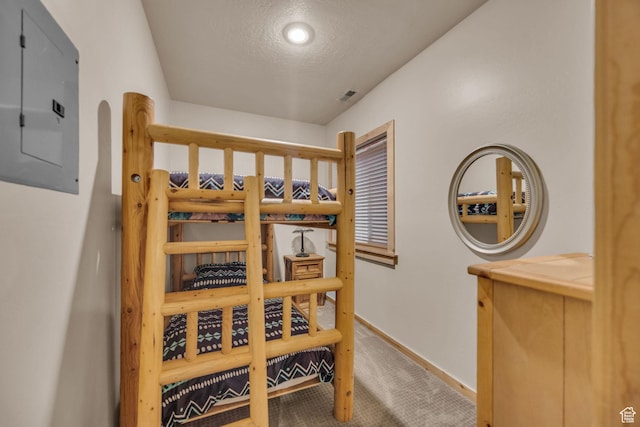5424 Bobsled Blvd Unit T2, Park City, UT 84098 - bedroom featuring baseboards, electric panel, carpet flooring, a textured ceiling, and visible vents