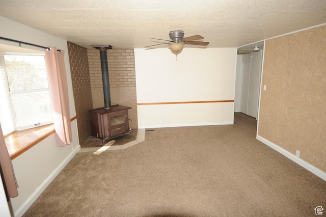 295 E 100 S, Centerfield, UT 84622 - unfurnished living room with a wood stove, ceiling fan, carpet, and baseboards