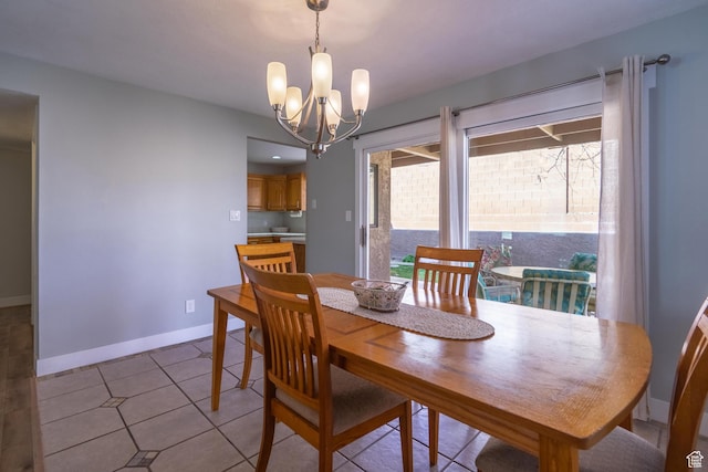 dining room with light tile patterned floors, an inviting chandelier, and baseboards