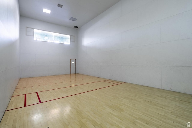 view of property's community featuring a sport court and visible vents