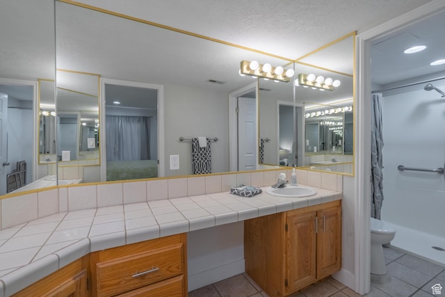 full bathroom with vanity, curtained shower, toilet, tile patterned flooring, and visible vents