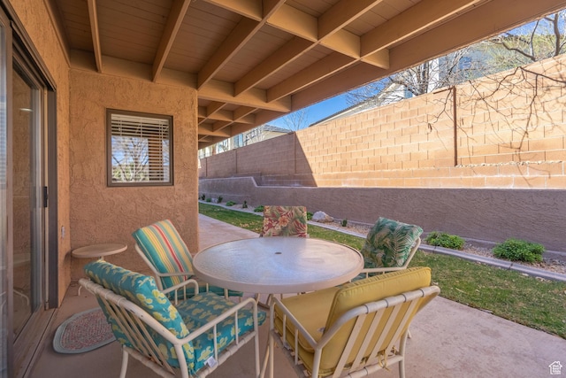 view of patio / terrace featuring outdoor dining area and fence