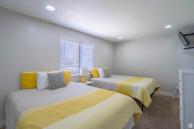 carpeted bedroom featuring baseboards and recessed lighting
