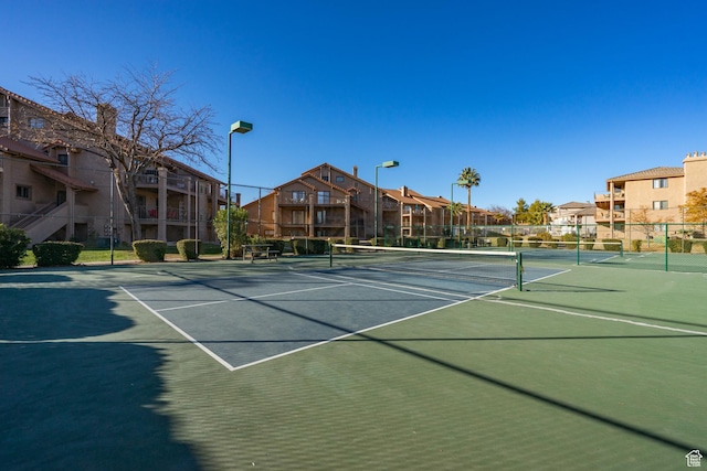 view of sport court featuring a residential view and fence