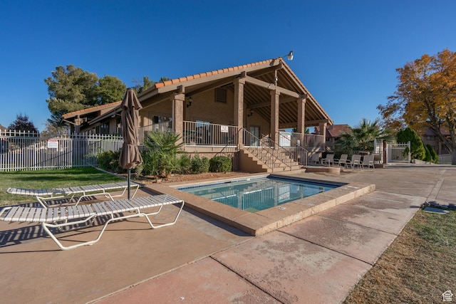 pool with fence and a patio area