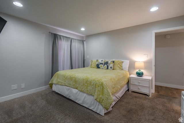 carpeted bedroom featuring baseboards and recessed lighting