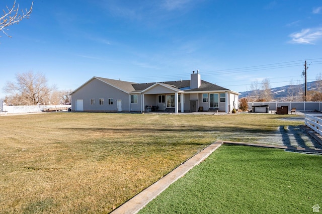 5185 N 600 E, Enoch, UT 84721 - rear view of house with a yard, fence, and a chimney