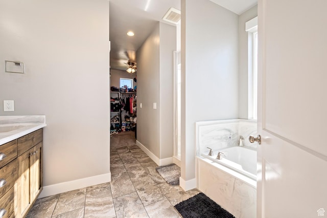 5185 N 600 E, Enoch, UT 84721 - full bath featuring vanity, a walk in closet, visible vents, a bath, and ceiling fan