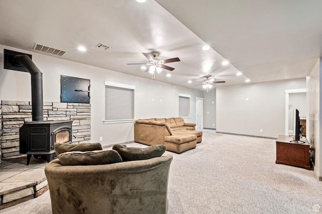 5185 N 600 E, Enoch, UT 84721 - living room with a wood stove, carpet flooring, visible vents, and a ceiling fan