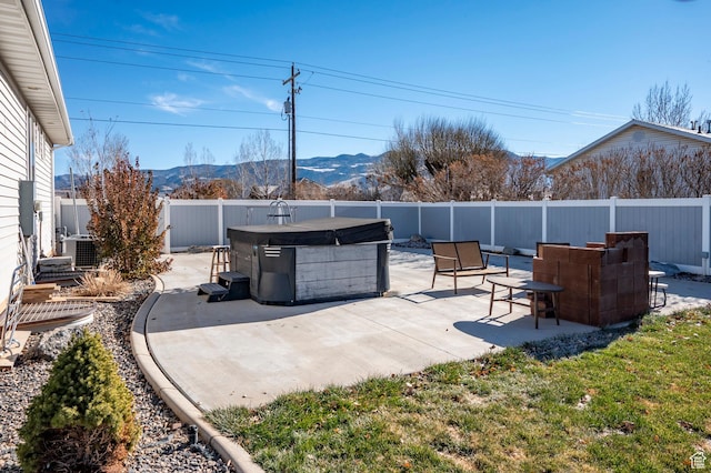 5185 N 600 E, Enoch, UT 84721 - view of patio featuring central air condition unit, a mountain view, a fenced backyard, and a hot tub