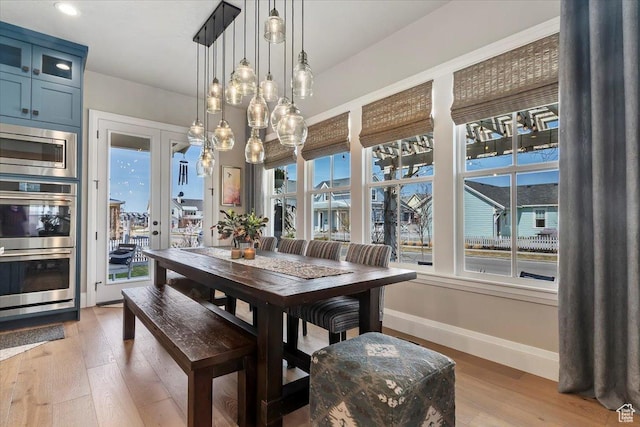 dining room featuring light wood-type flooring and baseboards