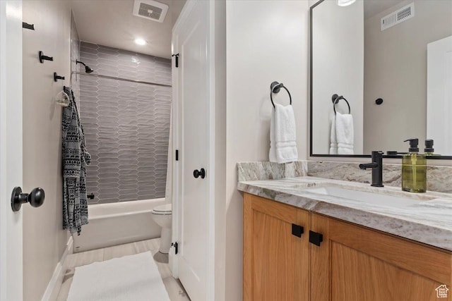full bathroom featuring toilet, vanity, shower / tub combination, and visible vents