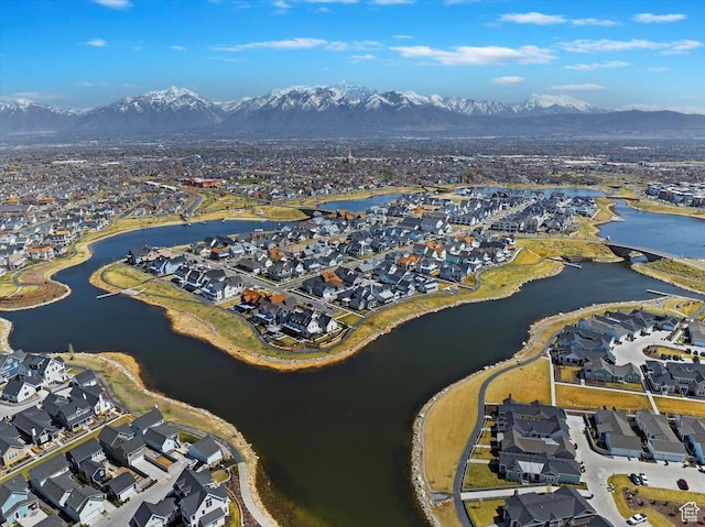 drone / aerial view with a water and mountain view and a residential view
