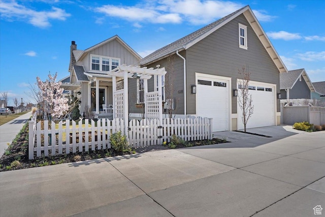 view of front of home featuring a chimney, a fenced front yard, a pergola, and driveway