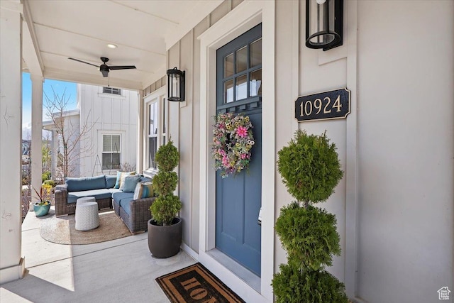 view of exterior entry with an outdoor living space, ceiling fan, covered porch, and visible vents