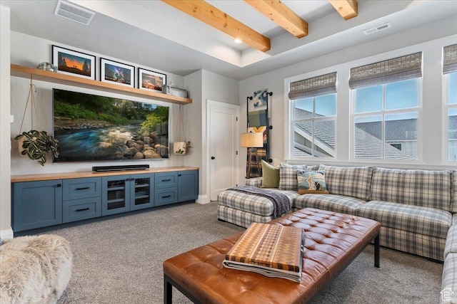 carpeted living area with visible vents, baseboards, and beamed ceiling