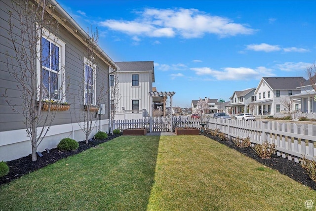 view of yard featuring a residential view and fence