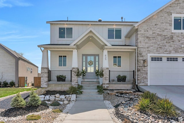craftsman house featuring board and batten siding, a garage, a porch, stone siding, and concrete driveway