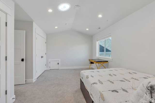 bedroom with carpet, visible vents, baseboards, and vaulted ceiling