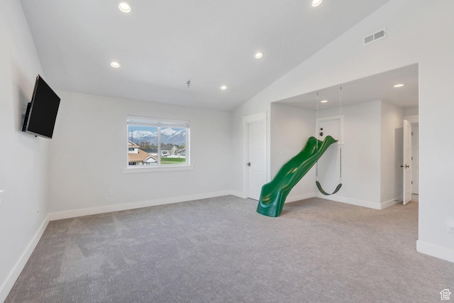 carpeted spare room with recessed lighting, visible vents, baseboards, and lofted ceiling