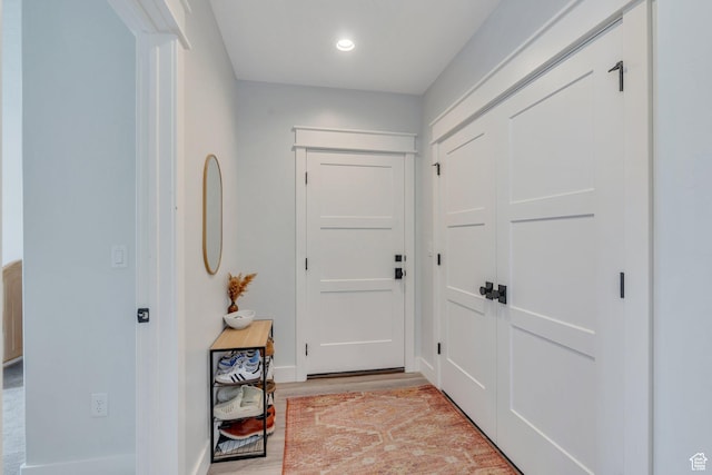 interior space featuring recessed lighting, light wood finished floors, and baseboards