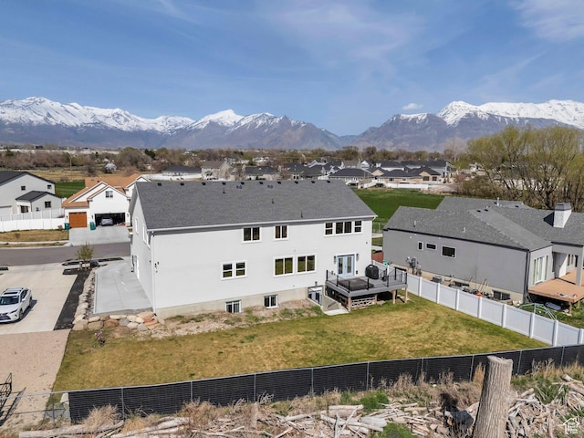 rear view of property featuring a residential view, fence private yard, and a mountain view