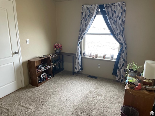 carpeted bedroom featuring visible vents