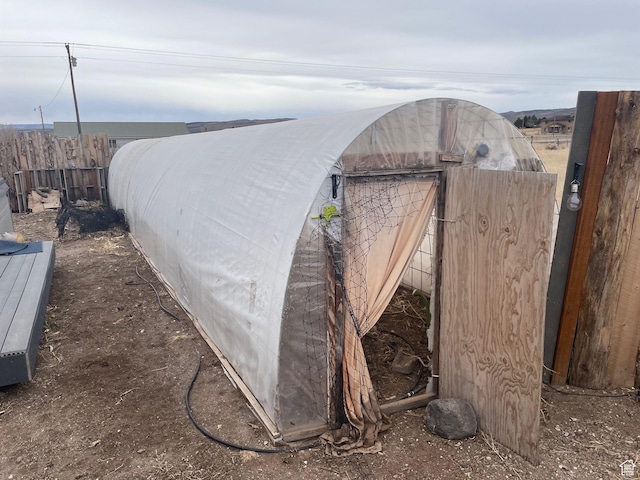 view of outbuilding featuring fence