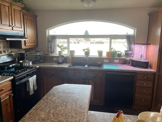 kitchen with black appliances, under cabinet range hood, a sink, and plenty of natural light