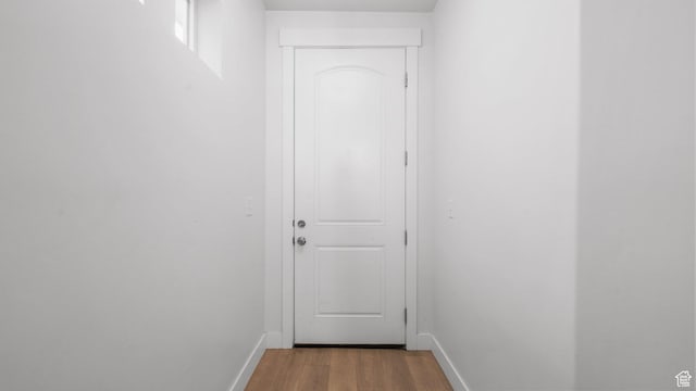 entryway featuring wood finished floors and baseboards