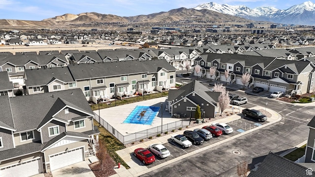 drone / aerial view featuring a residential view and a mountain view