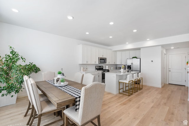 11612 S Watercourse Rd W, South Jordan, UT 84009 - dining space featuring light wood finished floors, baseboards, and recessed lighting
