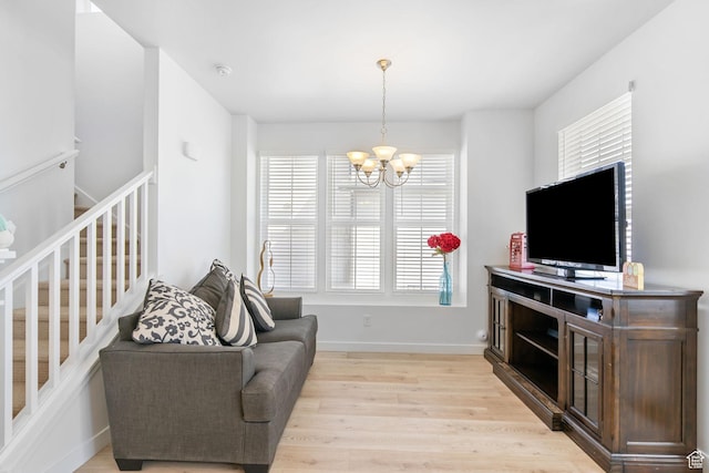 11612 S Watercourse Rd W, South Jordan, UT 84009 - living area featuring light wood finished floors, a notable chandelier, and baseboards