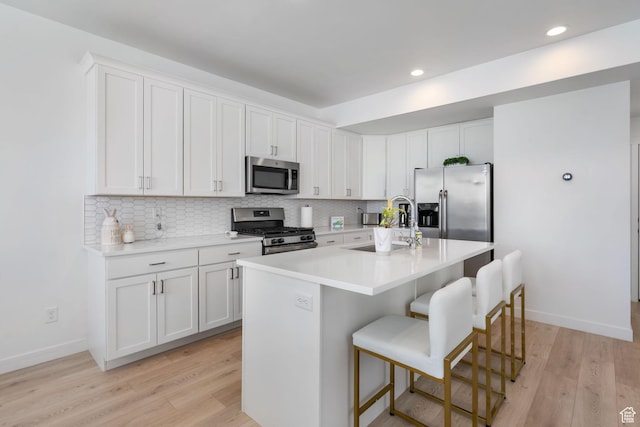 11612 S Watercourse Rd W, South Jordan, UT 84009 - kitchen featuring tasteful backsplash, light wood finished floors, and stainless steel appliances