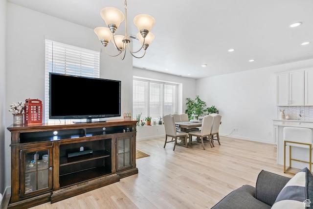 11612 S Watercourse Rd W, South Jordan, UT 84009 - living room featuring a chandelier, light wood-style floors, baseboards, and recessed lighting