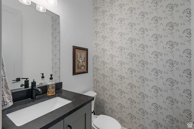 half bath featuring toilet and vanity