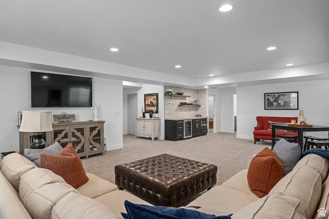 living area featuring indoor wet bar, light carpet, baseboards, and recessed lighting