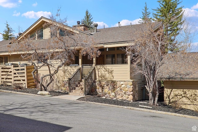 1335 Deer Valley Dr S, Park City, UT 84060 - view of front of home featuring roof with shingles, a porch, and a chimney
