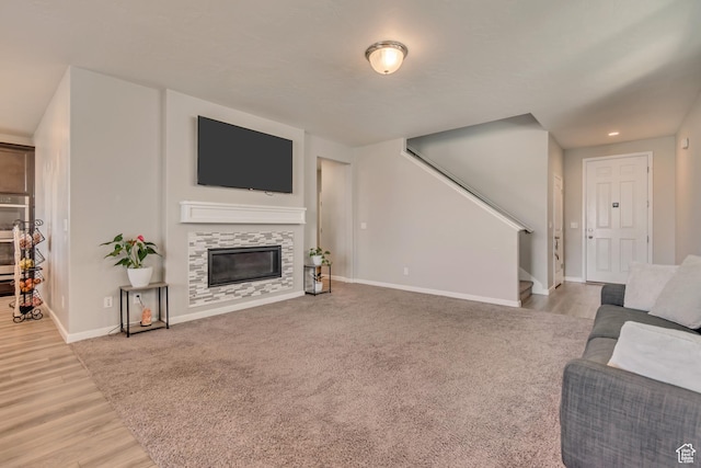 15191 S Ronaldo Ln, Herriman, UT 84096 - carpeted living area with stairs, a fireplace, baseboards, and wood finished floors