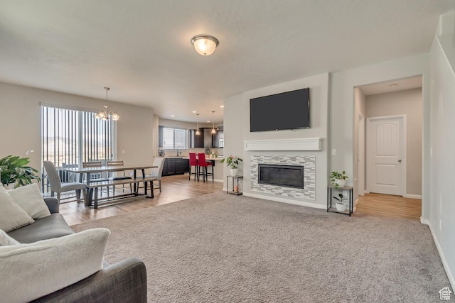 15191 S Ronaldo Ln, Herriman, UT 84096 - carpeted living room with a chandelier, a fireplace, baseboards, and recessed lighting