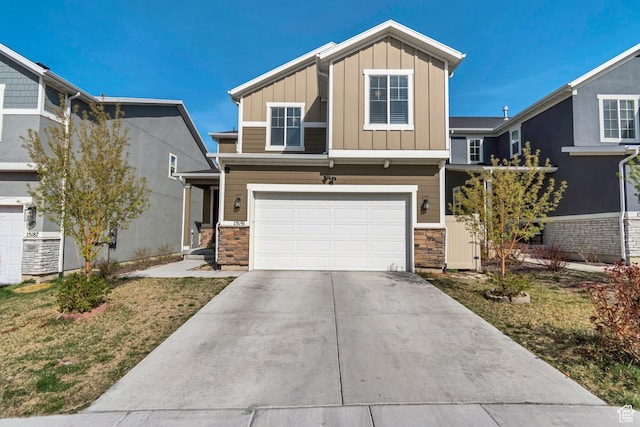 15191 S Ronaldo Ln, Herriman, UT 84096 - view of front of home featuring driveway, board and batten siding, stone siding, and an attached garage