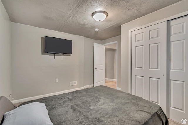 15191 S Ronaldo Ln, Herriman, UT 84096 - carpeted bedroom with a textured ceiling, a closet, and baseboards